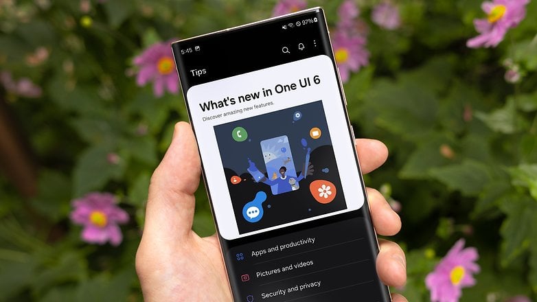 A person holding an Galaxy S23 Ultra showing the Samsung One UI 6 beta prompt update on display