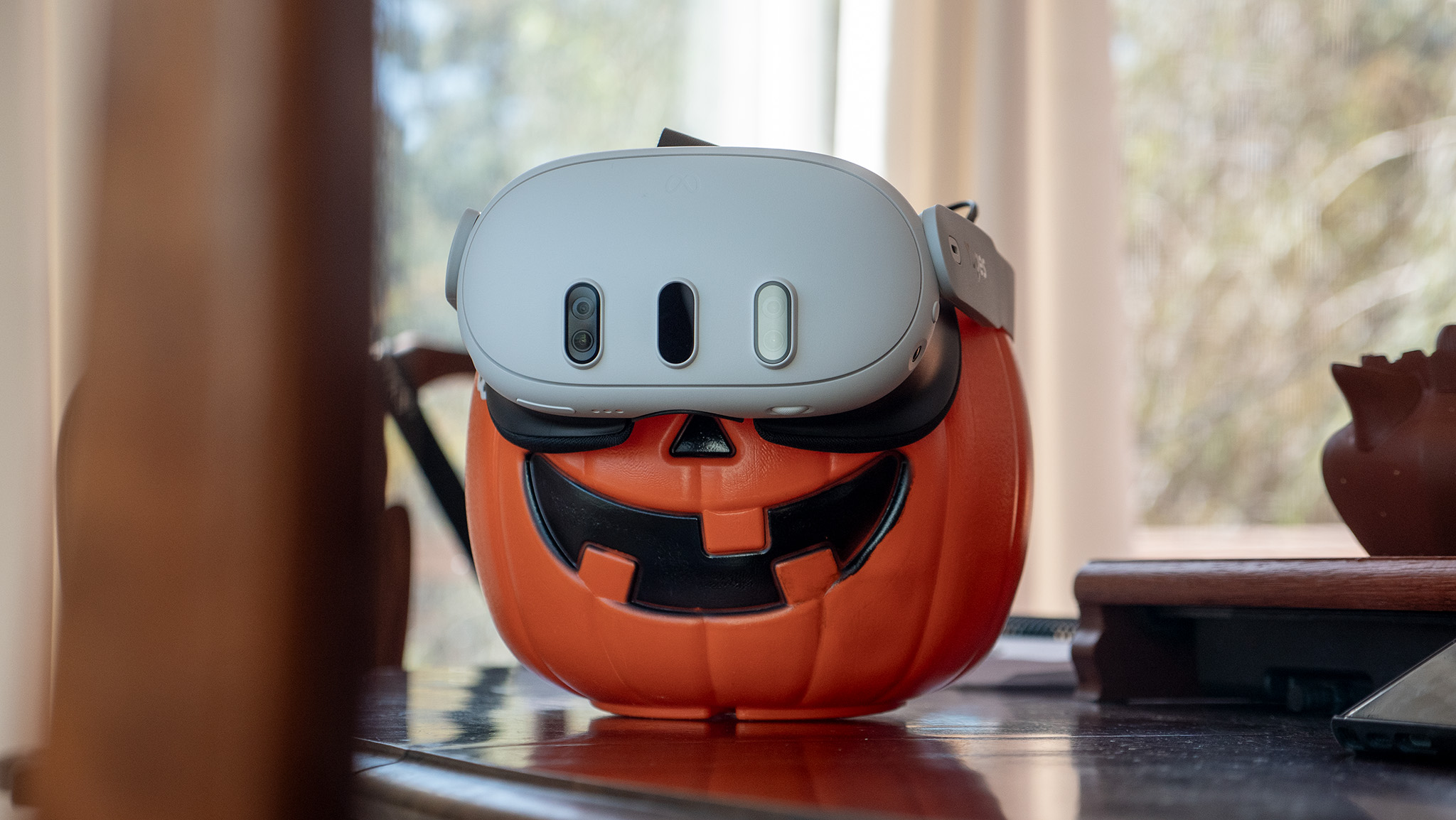 A pumpkin wearing a Meta Quest 3 headset
